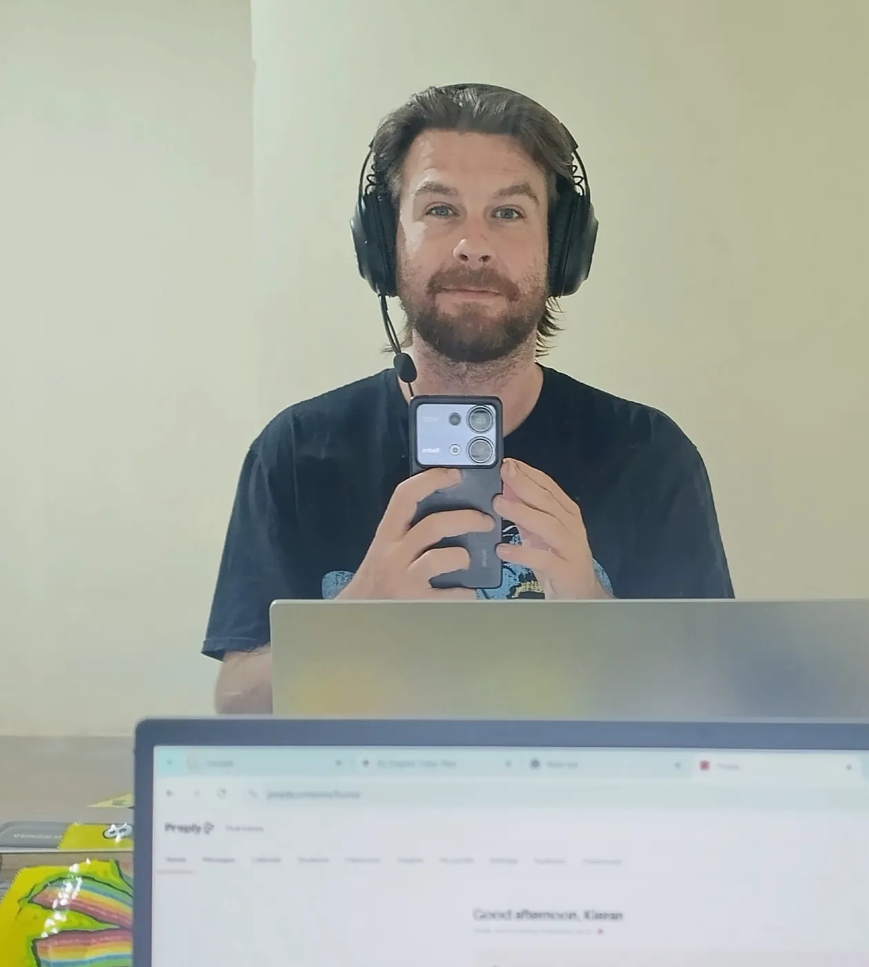 Kieran at his desk with a headset, ready for an online lesson